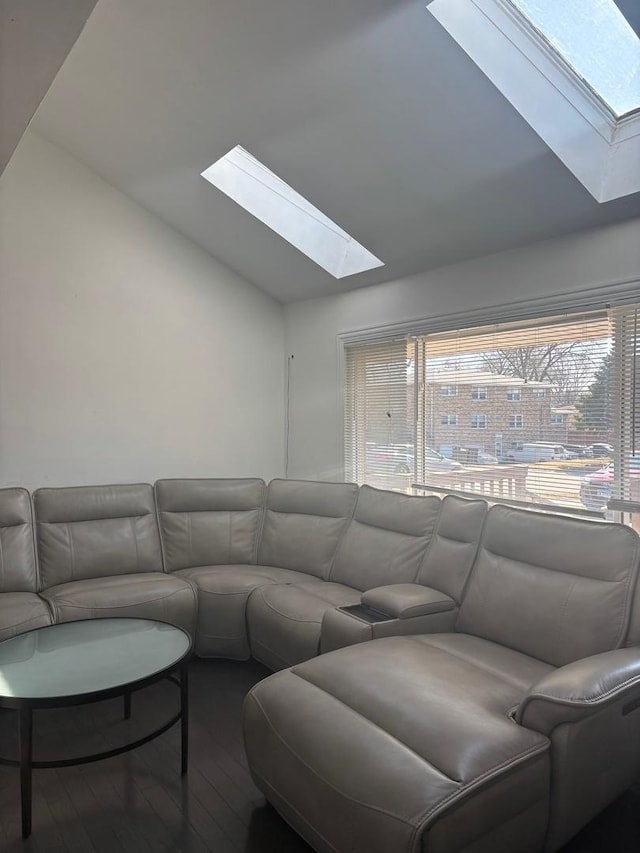 living room with lofted ceiling with skylight and wood finished floors