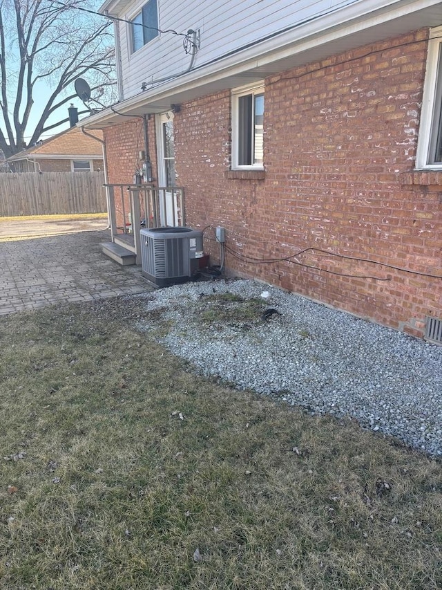 exterior space featuring cooling unit and fence