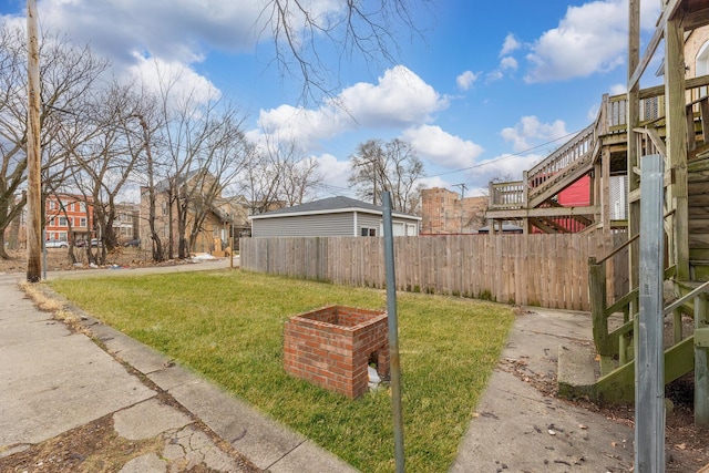 view of yard with stairs and fence