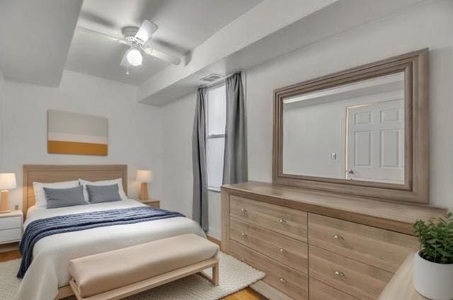 bedroom featuring a ceiling fan and wood finished floors