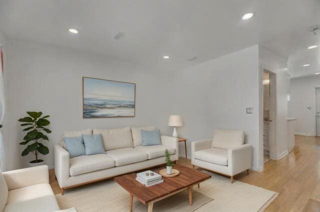 living area with light wood finished floors, recessed lighting, and baseboards