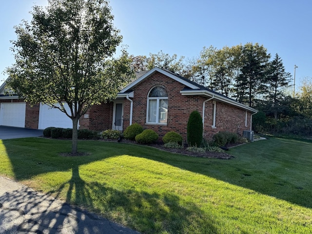 ranch-style home with central air condition unit, driveway, brick siding, and a front yard