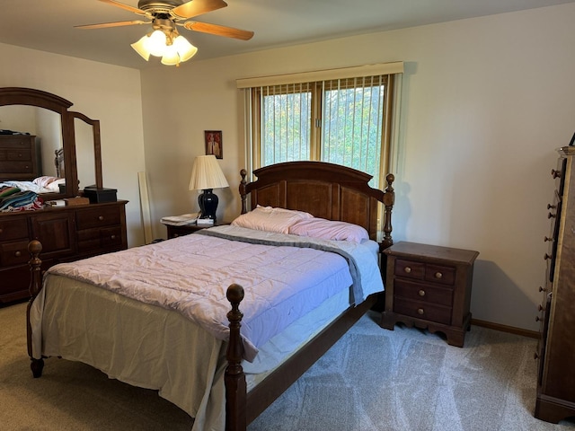 carpeted bedroom featuring baseboards and ceiling fan