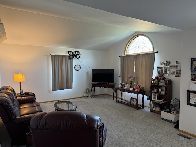 carpeted living area with vaulted ceiling, baseboards, and visible vents