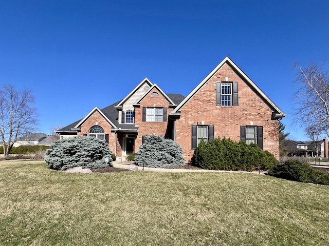 1904 Mullikin Dr, Champaign, IL 61822 - traditional-style house with brick siding and a front yard