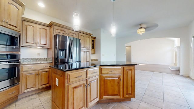 1904 Mullikin Dr, Champaign, IL 61822 - kitchen with light tile patterned flooring, pendant lighting, a center island, stainless steel appliances, and arched walkways