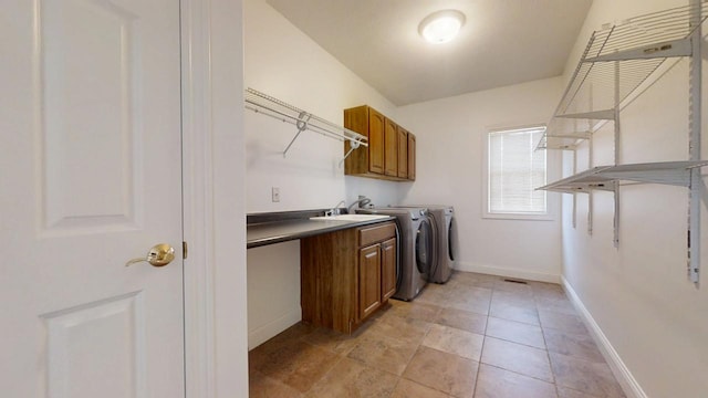 1904 Mullikin Dr, Champaign, IL 61822 - washroom with light tile patterned floors, baseboards, separate washer and dryer, a sink, and cabinet space