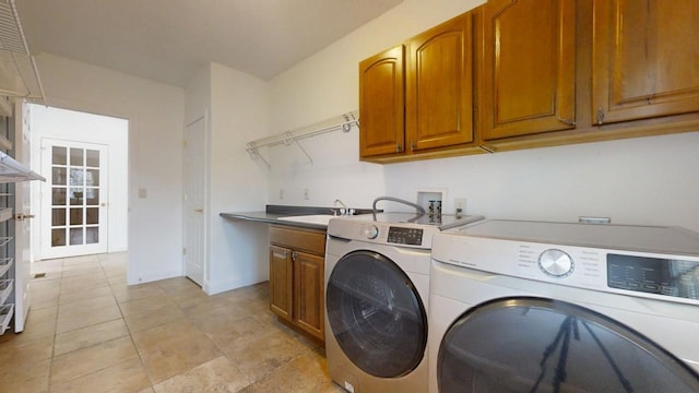 1904 Mullikin Dr, Champaign, IL 61822 - clothes washing area featuring light tile patterned flooring, washing machine and dryer, a sink, baseboards, and cabinet space
