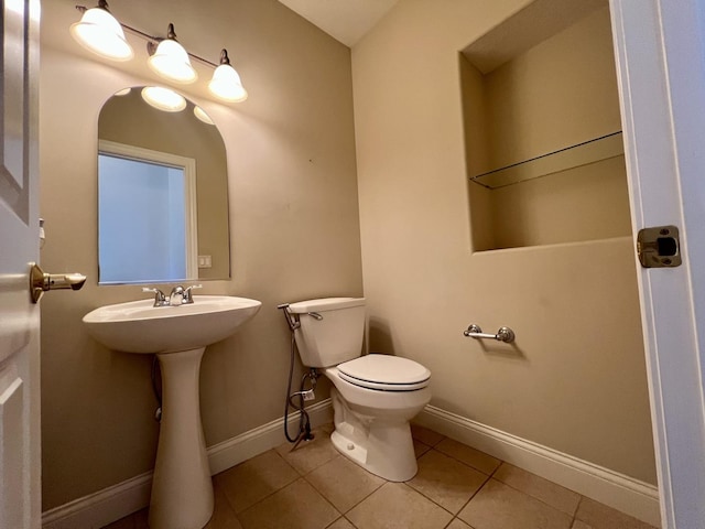 1904 Mullikin Dr, Champaign, IL 61822 - half bath with baseboards, toilet, tile patterned flooring, and a sink