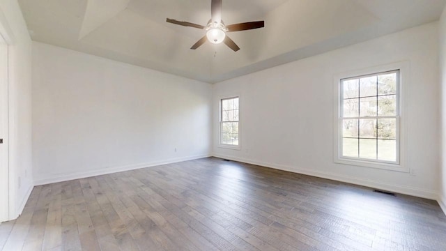 1904 Mullikin Dr, Champaign, IL 61822 - empty room featuring a ceiling fan, hardwood / wood-style flooring, baseboards, and a raised ceiling