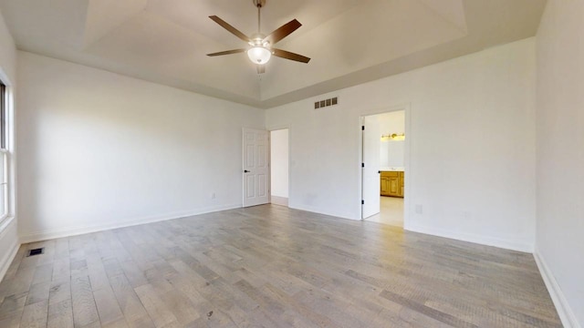 1904 Mullikin Dr, Champaign, IL 61822 - unfurnished room with a tray ceiling, a ceiling fan, baseboards, visible vents, and light wood-style floors