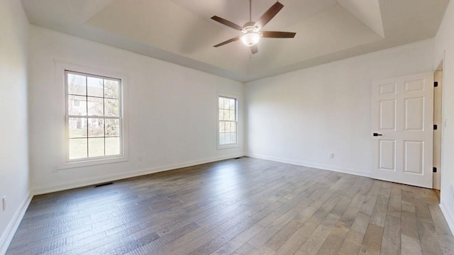 1904 Mullikin Dr, Champaign, IL 61822 - spare room with wood-type flooring, visible vents, a ceiling fan, and a raised ceiling