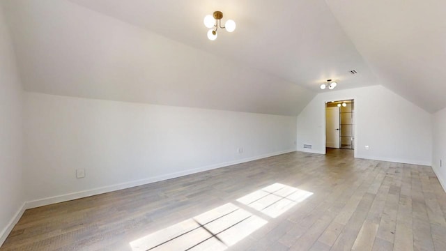 1904 Mullikin Dr, Champaign, IL 61822 - additional living space with light wood-style flooring, baseboards, lofted ceiling, and visible vents