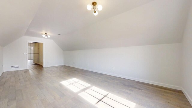 1904 Mullikin Dr, Champaign, IL 61822 - bonus room featuring baseboards, wood finished floors, and vaulted ceiling