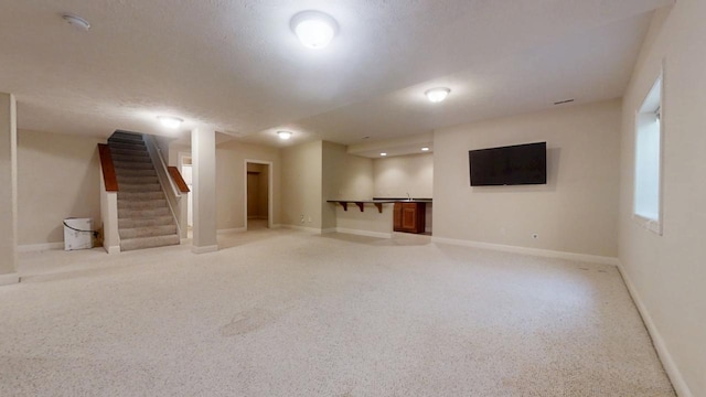 1904 Mullikin Dr, Champaign, IL 61822 - finished below grade area with baseboards, stairs, a textured ceiling, and light colored carpet