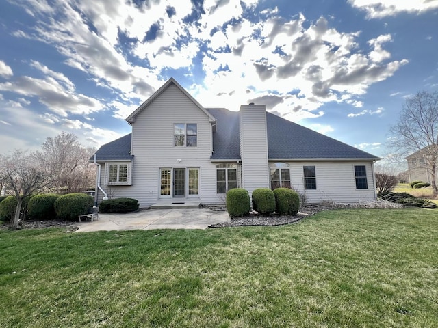 1904 Mullikin Dr, Champaign, IL 61822 - back of house with a lawn, a chimney, a shingled roof, and a patio area