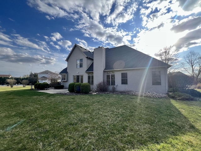 1904 Mullikin Dr, Champaign, IL 61822 - exterior space with a chimney, a front yard, and a patio area
