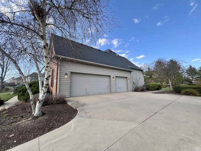 1904 Mullikin Dr, Champaign, IL 61822 - view of property exterior featuring driveway, a shingled roof, and a garage