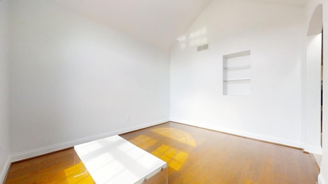 1904 Mullikin Dr, Champaign, IL 61822 - empty room with wood finished floors, baseboards, built in shelves, and visible vents