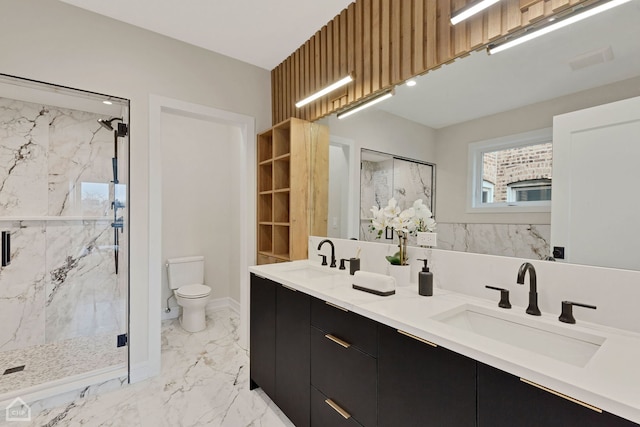 full bath featuring a marble finish shower, marble finish floor, toilet, and a sink