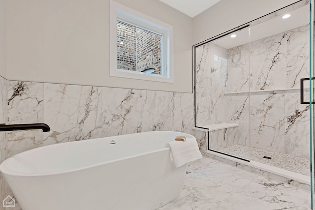 full bathroom with a marble finish shower, recessed lighting, a freestanding bath, tile walls, and marble finish floor