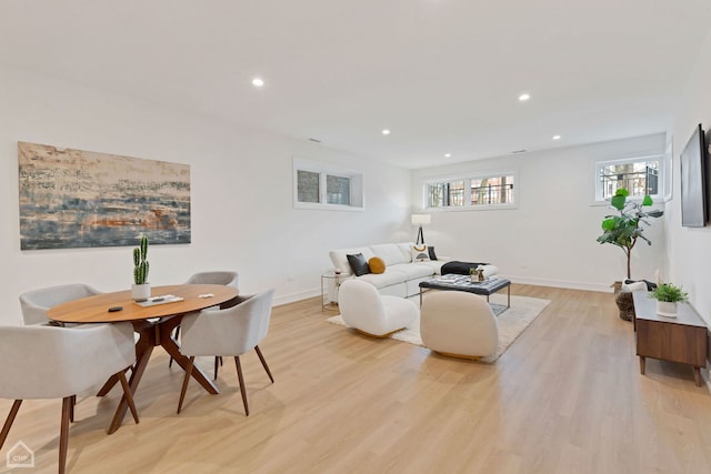 living area with recessed lighting, baseboards, and light wood-style floors