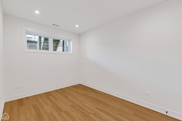 unfurnished room with visible vents, recessed lighting, light wood-type flooring, and baseboards