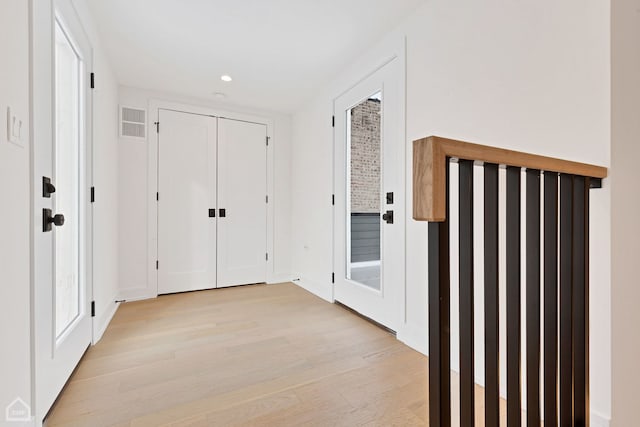 corridor with visible vents, recessed lighting, and light wood-type flooring