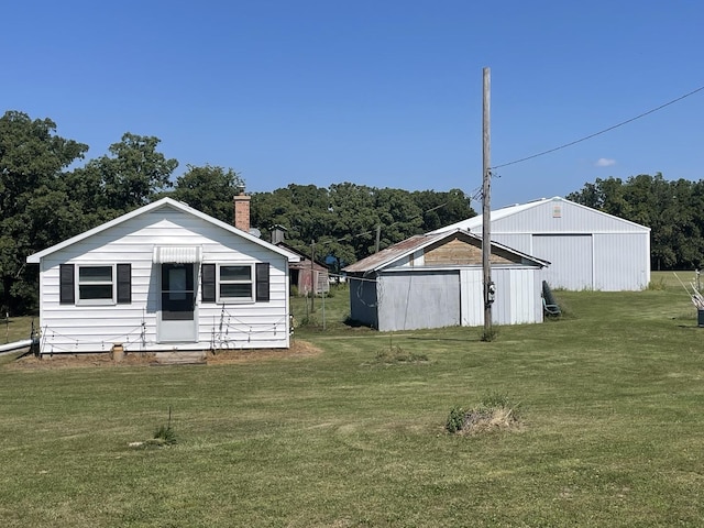 view of yard with an outbuilding, a garage, and an outdoor structure