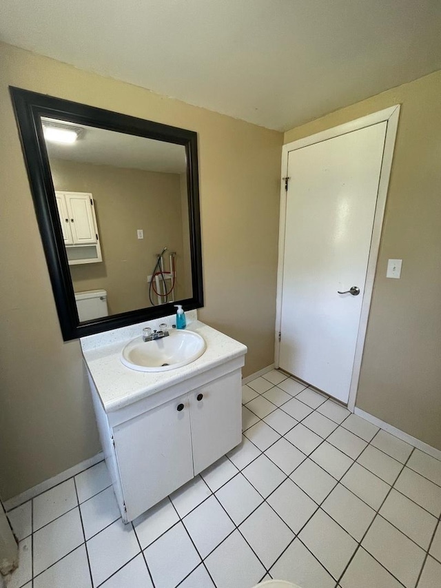 bathroom featuring vanity, baseboards, and tile patterned flooring