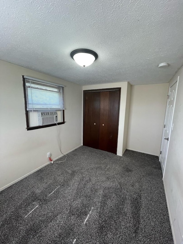 unfurnished bedroom with a closet, carpet, and a textured ceiling