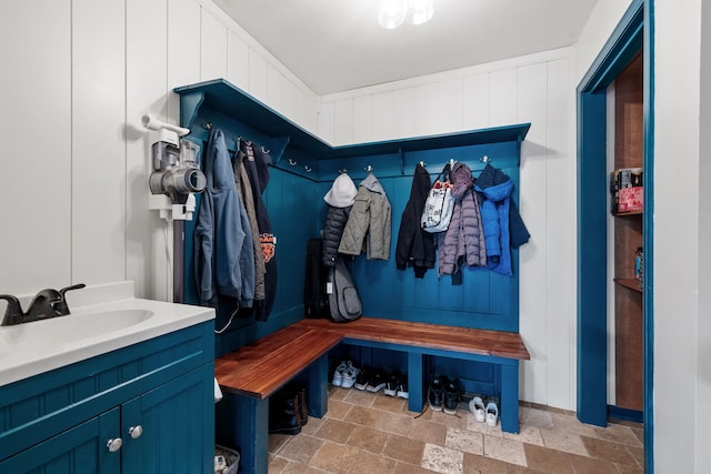 mudroom featuring stone tile flooring and a sink