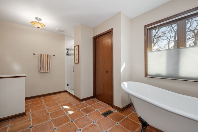 full bath with visible vents, baseboards, a freestanding bath, and a stall shower