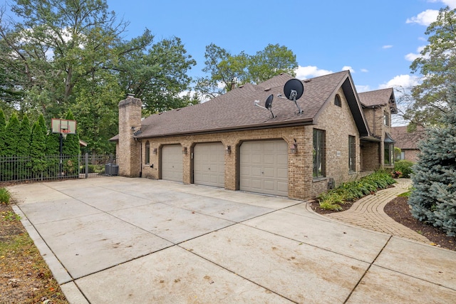 view of home's exterior with driveway, fence, a shingled roof, a garage, and brick siding