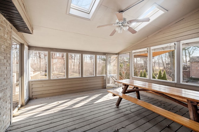 unfurnished sunroom with lofted ceiling with skylight and ceiling fan