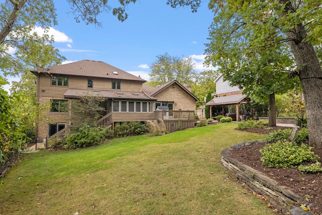 view of yard with a gazebo, a wooden deck, fence, and a sunroom