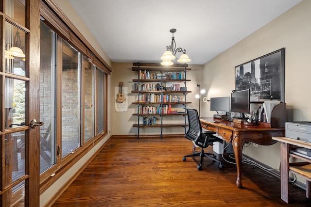 office area featuring a notable chandelier, baseboards, and wood finished floors