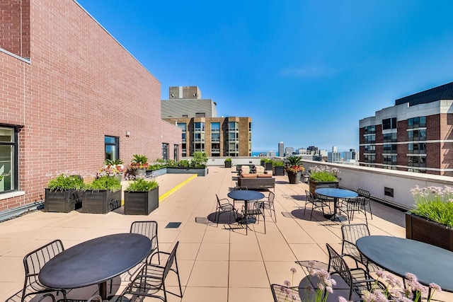 view of patio featuring outdoor dining space and a view of city