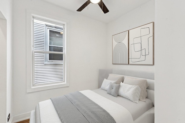 bedroom featuring baseboards and a ceiling fan