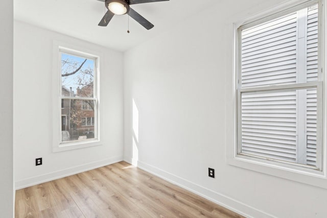 unfurnished room with ceiling fan, light wood-style flooring, and baseboards