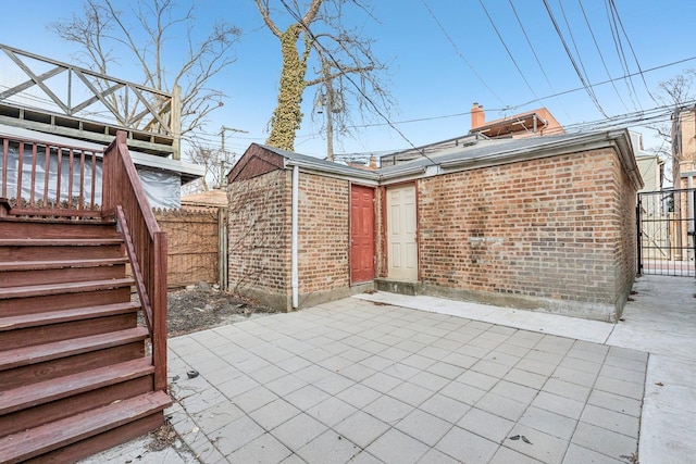 view of patio / terrace featuring stairs and fence