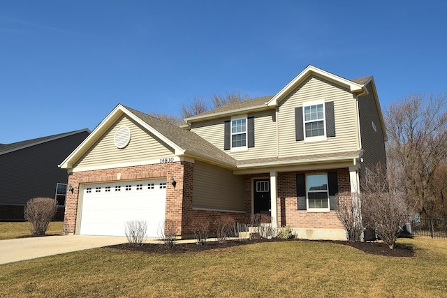 traditional-style house with a front lawn, brick siding, an attached garage, and driveway