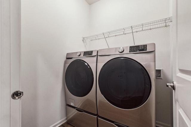 laundry room with washer and dryer, baseboards, and laundry area