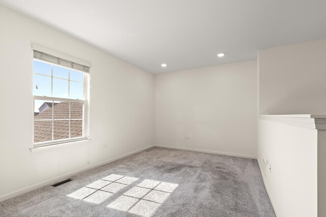 spare room with visible vents, recessed lighting, baseboards, and carpet