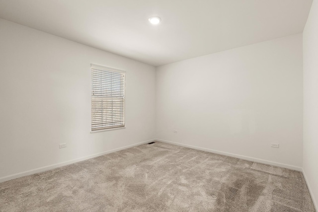 unfurnished room featuring baseboards and carpet floors