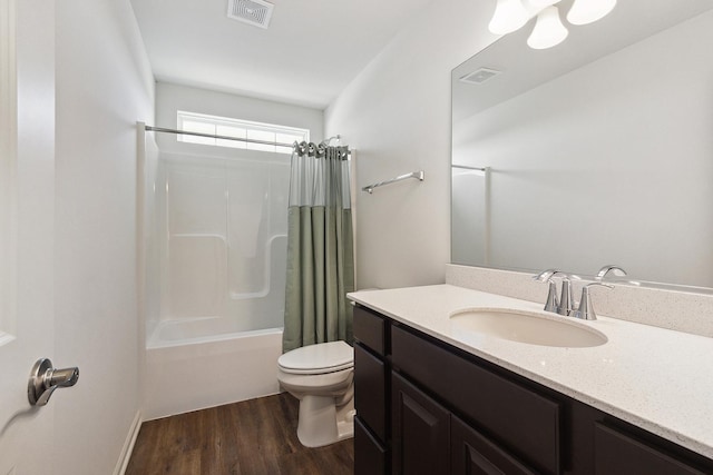 full bathroom with toilet, wood finished floors, visible vents, and shower / bath combo