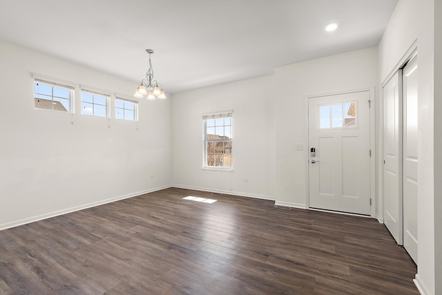 foyer featuring recessed lighting, baseboards, dark wood-type flooring, and an inviting chandelier