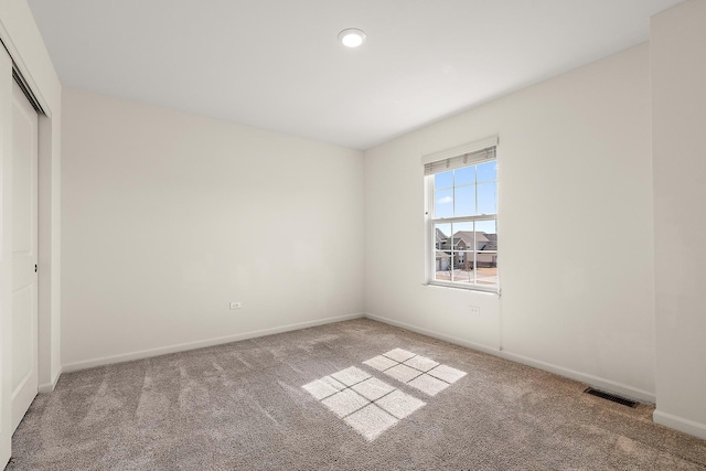 unfurnished bedroom featuring a closet, visible vents, baseboards, and carpet floors