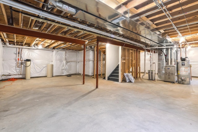 unfinished basement with gas water heater, stairway, heating unit, and visible vents