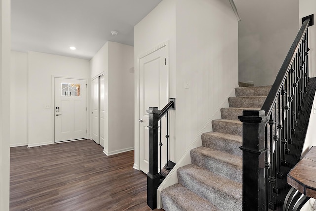 foyer featuring stairway, recessed lighting, dark wood-type flooring, and baseboards